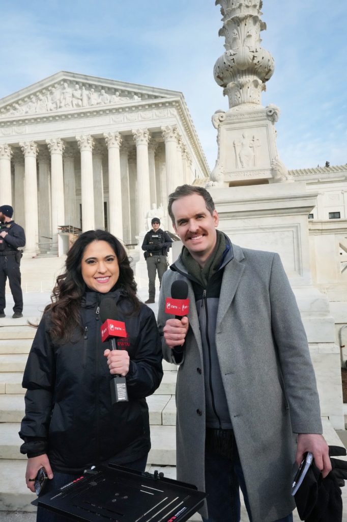 Two EWTN staff holding the EWTN Microphones and smiling