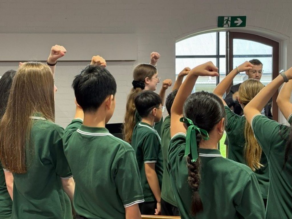 Australian Children's Choir singing using solfege - upper doh - facing their conductor.
