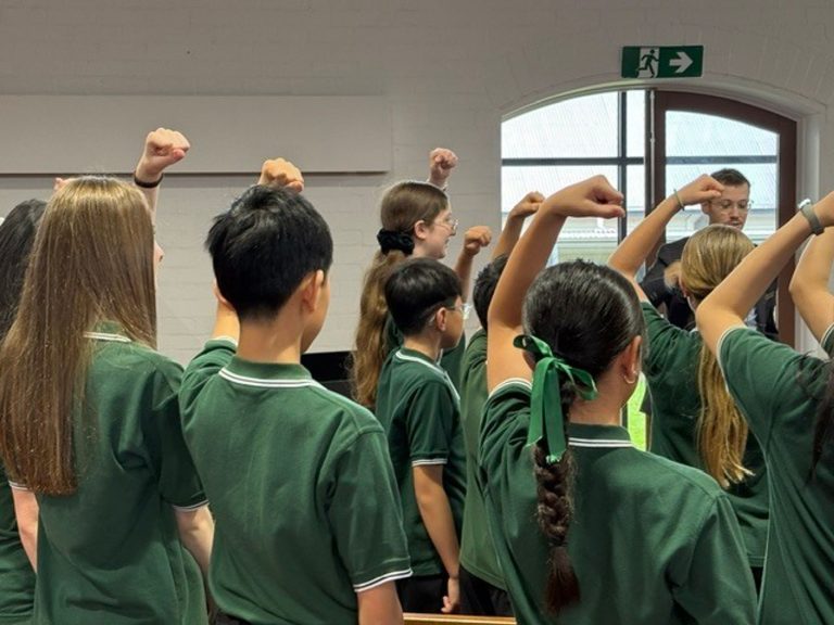 Australian Children's Choir singing using solfege - upper doh - facing their conductor.