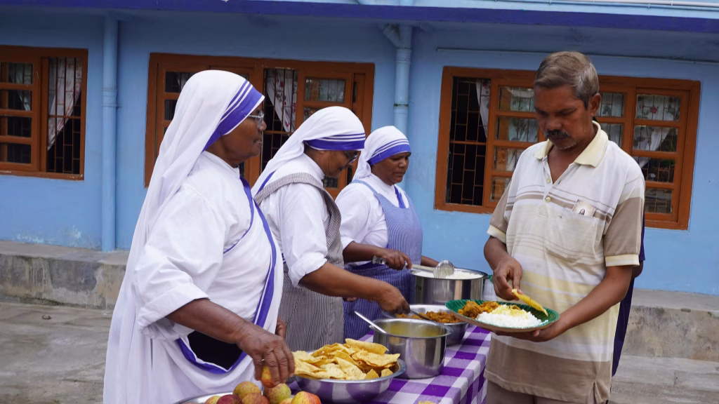 Missionaries of Charity sisters serve food to a man at the Jail Road convent in Ranchi, India.
