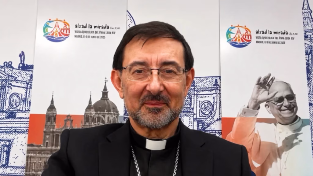 Spain Archbishop José Cobo Cano of Madrid infront of banners with Pope Leo XIV pictured on them with words in Spanish.
