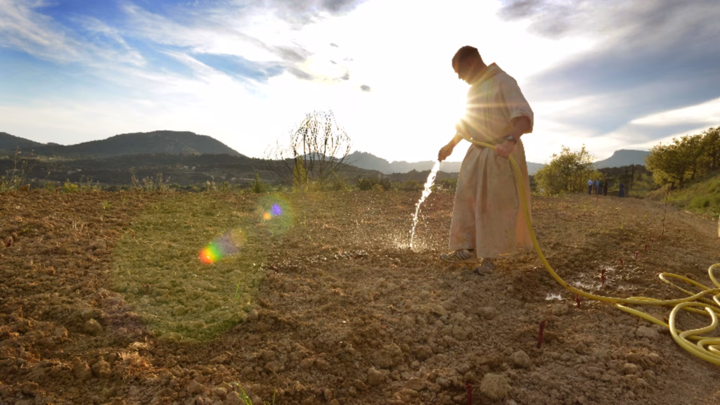 Monk watering the lawn.