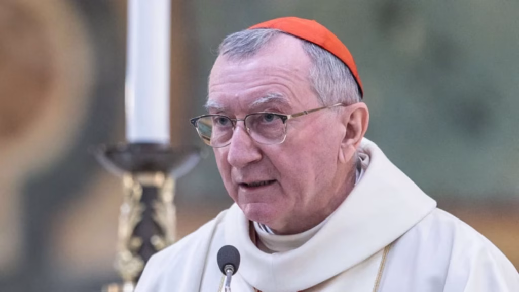 Cardinal Pietro Parolin, Vatican secretary of state, taking at a microphone with a serious look on his face.