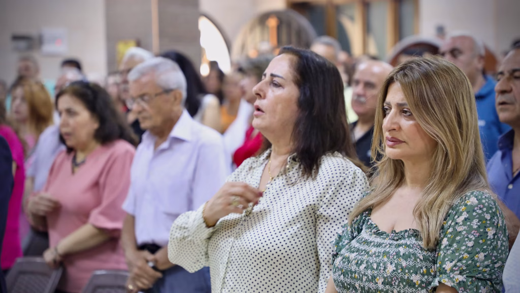Syrian people pray at the first Divine Liturgy since the war.
